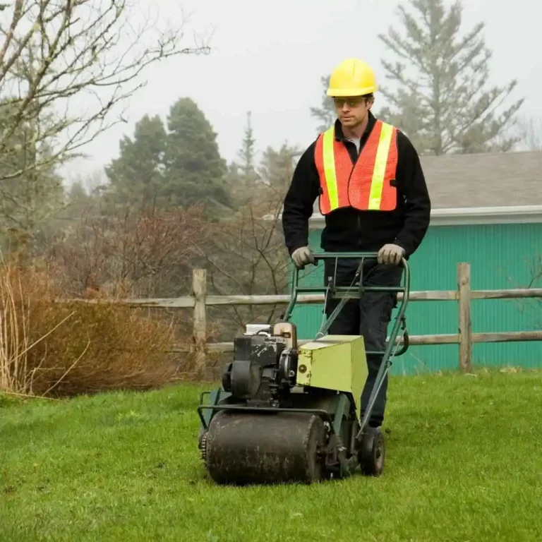 A professional landscaper mowing a lush green lawn with a commercial lawn mower on a sunny day.