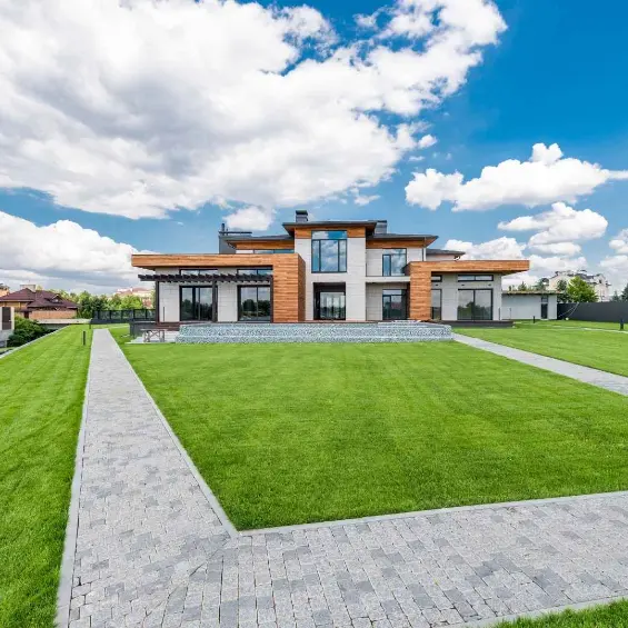 Modern detached home with a mown lawn and paver path