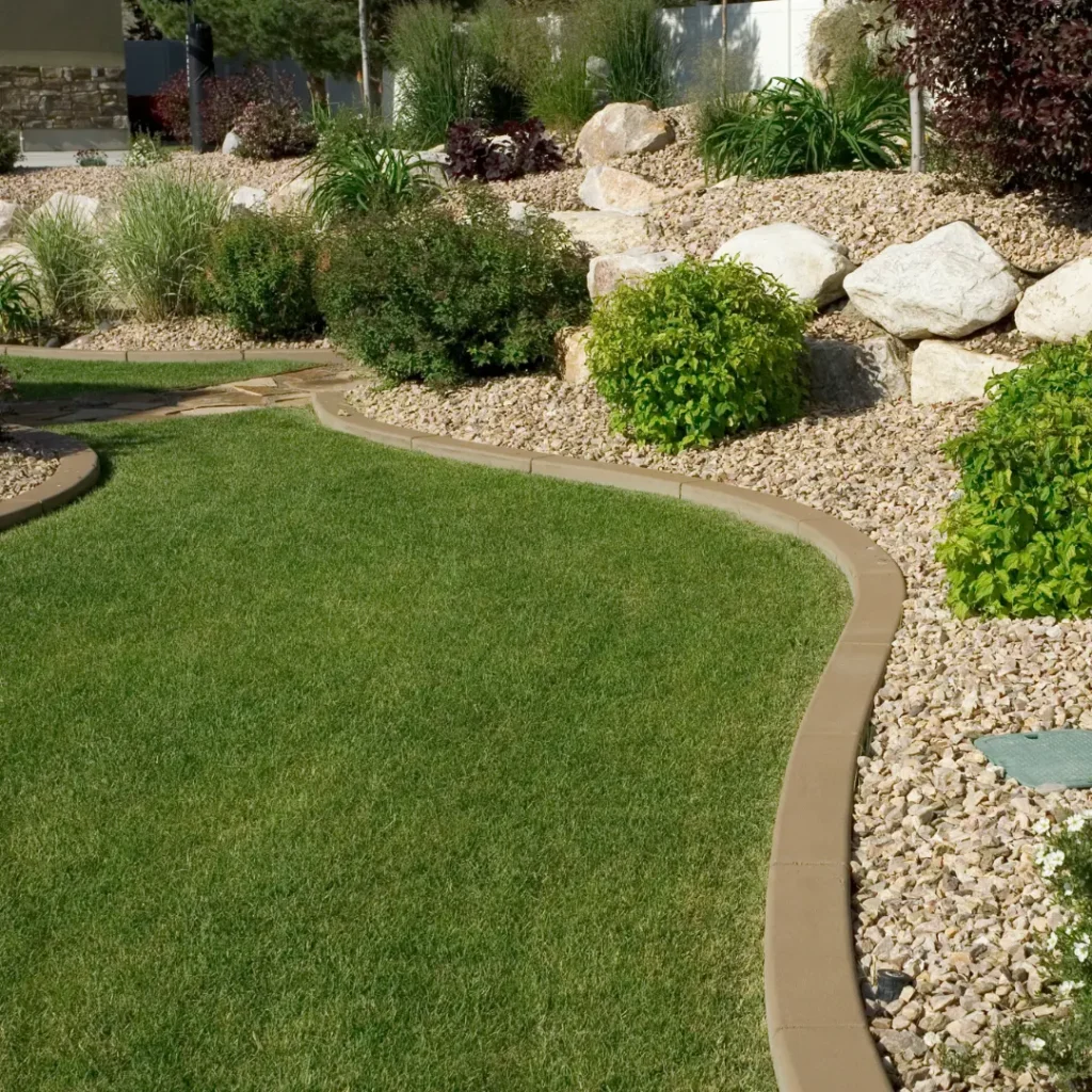 Curved lawn edge and rock garden planting on a Surrey property
